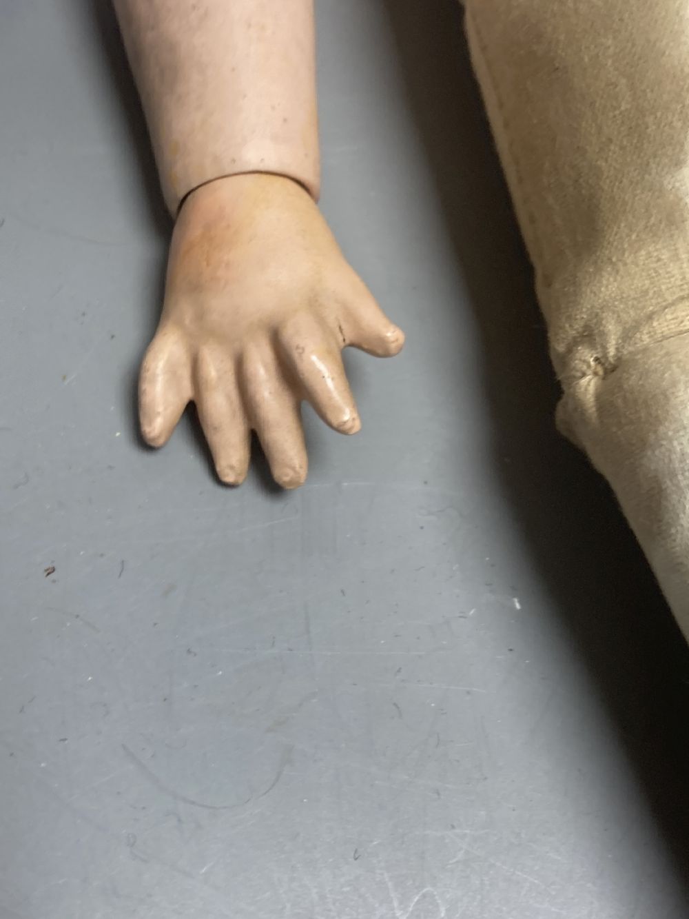 An Armand Marseille bisque boy doll, mould 990 with fixed glass eyes, 30cm, a bisque doll with jointed composition body, 47cm and a pai